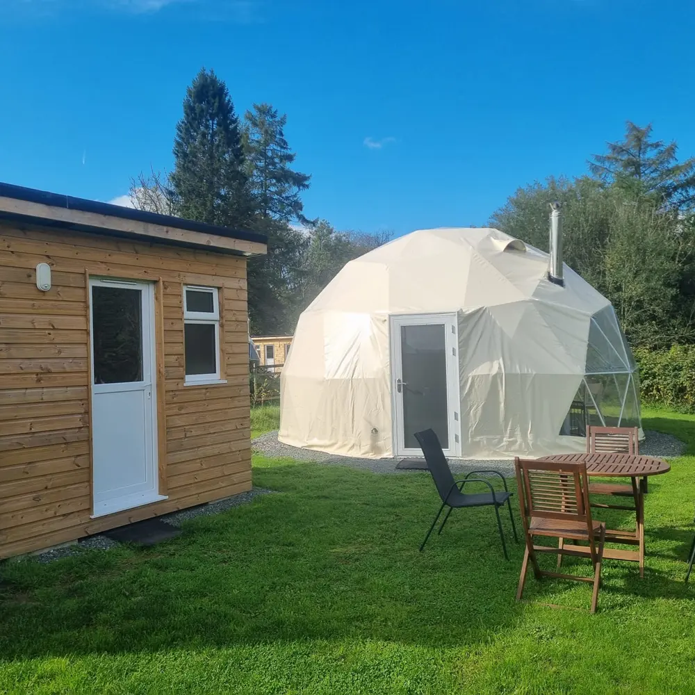 outside Lloer dome with log burner outside Lloer Geodome with log burner